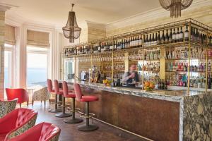 a bar with red stools in a restaurant at Harbour Hotel & Spa St Ives in St Ives