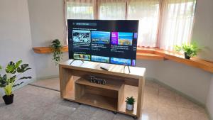 a flat screen tv sitting on top of a table at Rincon de la Araucaria Dina Huapi in Dina Huapi