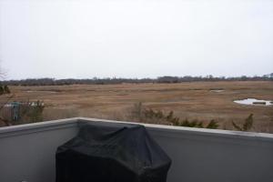 a view of a field from a balcony at 803 St James Place in Cape May