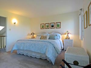 a bedroom with a white bed and two lamps at 803 St James Place in Cape May