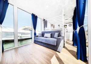 阿尔盖罗Alghero houseboat Blue Zone的带沙发和大窗户的客厅