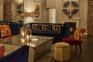a living room with a couch and a table and chairs at Harbour Hotel & Spa St Ives in St Ives