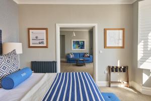 a bedroom with a bed and a living room at Harbour Hotel & Spa St Ives in St Ives