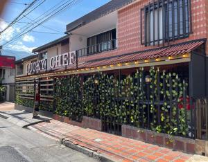 a grocery store with a wall covered in plants at Hotel boutique San Pablo H10 in Medellín