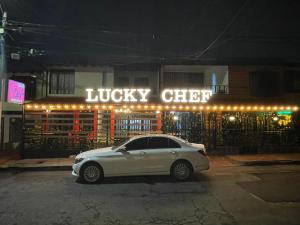 a white car parked in front of a music club at Hotel boutique San Pablo H10 in Medellín +8 photos