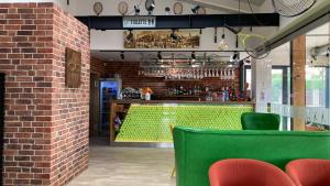 a bar with a green counter and a brick wall at Útulný 3 izbový byt v tichej lokalite in Trnava