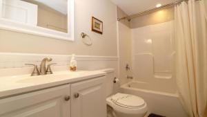 a bathroom with a sink and a toilet and a shower at Ca De Cha in West Cape May +18 photos
