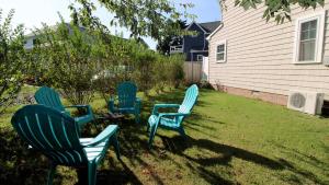 three blue chairs and a table in a yard at Ca De Cha in West Cape May