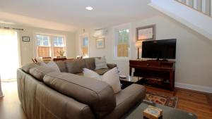 a living room with a couch and a flat screen tv at Ca De Cha in West Cape May