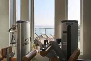 a gym with exercise equipment in front of a window at Harbour Hotel & Spa St Ives in St Ives