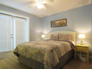 a bedroom with a bed and a window at Driftwood Condo 15 in Cape May