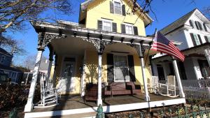 an american flag on the front porch of a house at The Daisy Cottage- Whole House Rental in Cape May