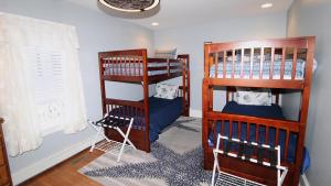a room with two bunk beds and a window at The Daisy Cottage- Whole House Rental in Cape May