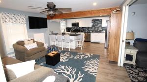 a living room with a couch and a kitchen at The Daisy Cottage- Whole House Rental in Cape May