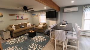 a living room with a couch and a table at The Daisy Cottage- Whole House Rental in Cape May