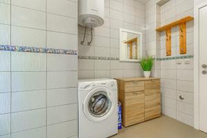 a laundry room with a washing machine in it at Luxury Beach app P2 amazing location in Ivan Dolac