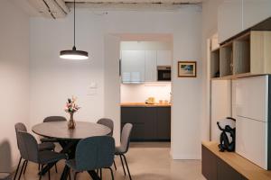 a kitchen and dining room with a table and chairs at Easy Flat 20 Settembre in Turin