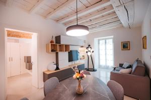 a living room with a table and a couch at Easy Flat 20 Settembre in Turin