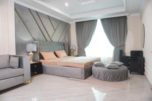 a bedroom with a bed and a couch and a chair at Bhurban Homes in Murree