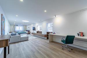 a large living room with a couch and a chair at Symphony Apartment with free parking in Kaunas