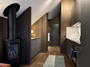 a kitchen with a woodburning stove and a sink at Lindvallen Ski Resort Pool and Padel - Sauna - 4 Guests in Sälen