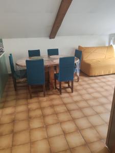 a room with a table and chairs and a bed at Les deux cascades in Sainte-Eulalie