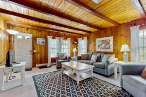a living room with a couch and a table at Cape Beach Bungalow in Dennis Port