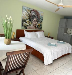 a bedroom with two beds and a painting on the wall at Newly renovated studio in Simpson Bay