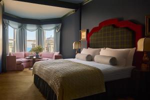 a bedroom with a large bed and a living room at Portrush Adelphi in Portrush