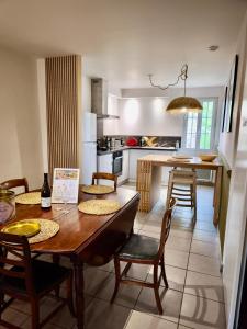 a kitchen with a table and chairs and a dining room at La Maison de l'Aqueduc in Cournanel +17 photos
