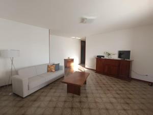 a living room with a couch and a coffee table at Appartamento Confine in Concordia Sagittaria