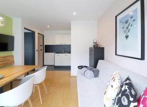 a living room and kitchen with a couch and a table at Apartment Luis 4 - Alpstay in Naturno