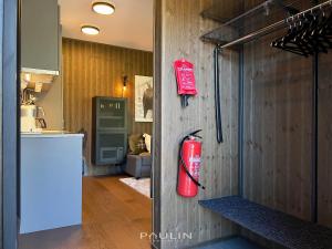 a fire extinguisher hanging on the wall of a kitchen at Lindvallen Ski Resort Pool and Padel - Sauna - 4 Guests in Sälen +26 photos