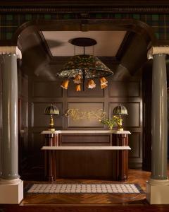 a chandelier hanging from a ceiling in a room at Portrush Adelphi in Portrush