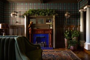a living room with a fireplace and a couch at Portrush Adelphi in Portrush