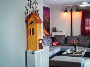 a living room with a bird house on a refrigerator at Comfort Stay in Preveza
