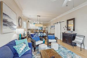 a living room with a blue couch and chairs at Seaside Sanctuary @ Litchfield by the Sea in Pawleys Island