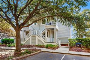 a large white house with a staircase on it at Seaside Sanctuary @ Litchfield by the Sea in Pawleys Island