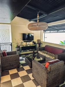 a living room with two couches and a television at Finca Bellavista Villeta in Villeta