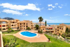an aerial view of a villa with a swimming pool and apartments at Pilar Luxury Apartment in Benalmádena
