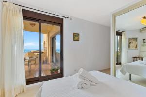 a bedroom with a bed and a view of the ocean at Pilar Luxury Apartment in Benalmádena +27 photos