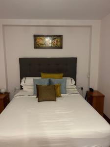 Un dormitorio con una gran cama blanca con almohadas amarillas. en House -Sleeps 6-Garden-Fireplace, en Alicante 29 fotos más