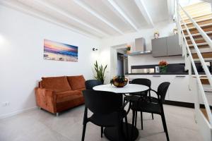 a living room with a table and chairs and a couch at Ivi's House in Palermo
