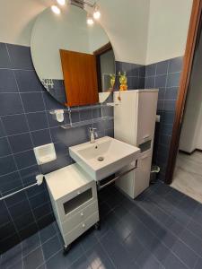 a bathroom with a white sink and a mirror at Appartamento AZZURRO in Pesaro