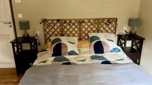a bed with two pillows on it in a bedroom at L'Arlésienne in Arles