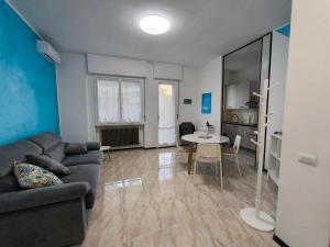 a living room with a couch and a table at Appartamento AZZURRO in Pesaro +20 photos