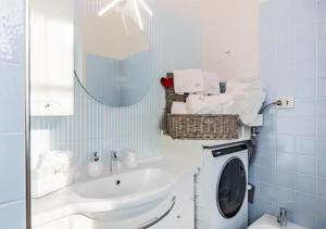 a bathroom with a washing machine and a sink at La finestra dei Batù by Alterego in Villanova dʼAsti +20 photos