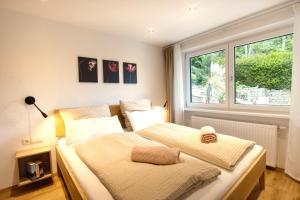 a bedroom with two beds and a window at Apartment MarLen in Eben am Achensee