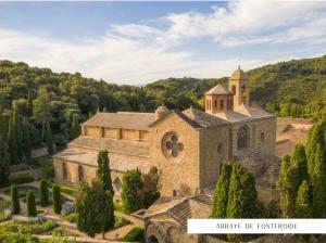 an aerial view of a large stone church at Bienvenue chez Sandrine in Laredorte +30 photos