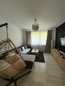 a living room with a couch and a swing at Seli Apartment in Bremerhaven